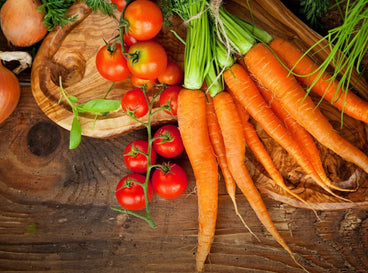An overhead flatlay shot of several crops that showcases carrot companion plants
