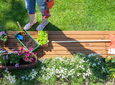 An overhead shot of a person getting ready for March garden tasks